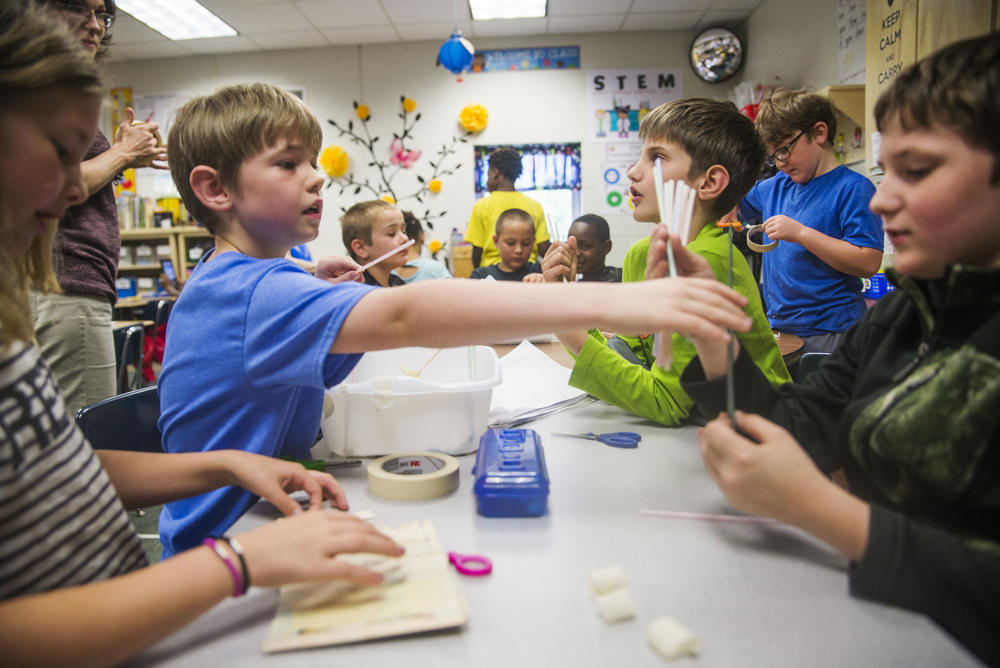 Third Grade students at Northside Elementary School in Warner Robins work together on building bridges of plastic straws and masking tape.
