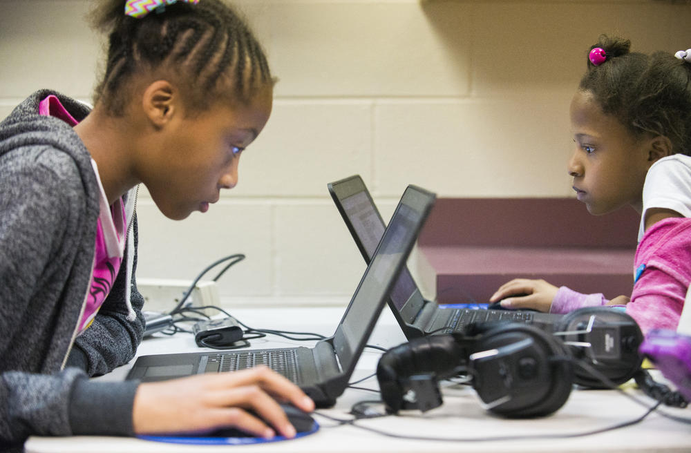 Victoria Homer, left, and Kayla Holston work on cartoons of their own design using blocks of computer code during a STEM focused class at Northside Elementary School in Warner Robins.