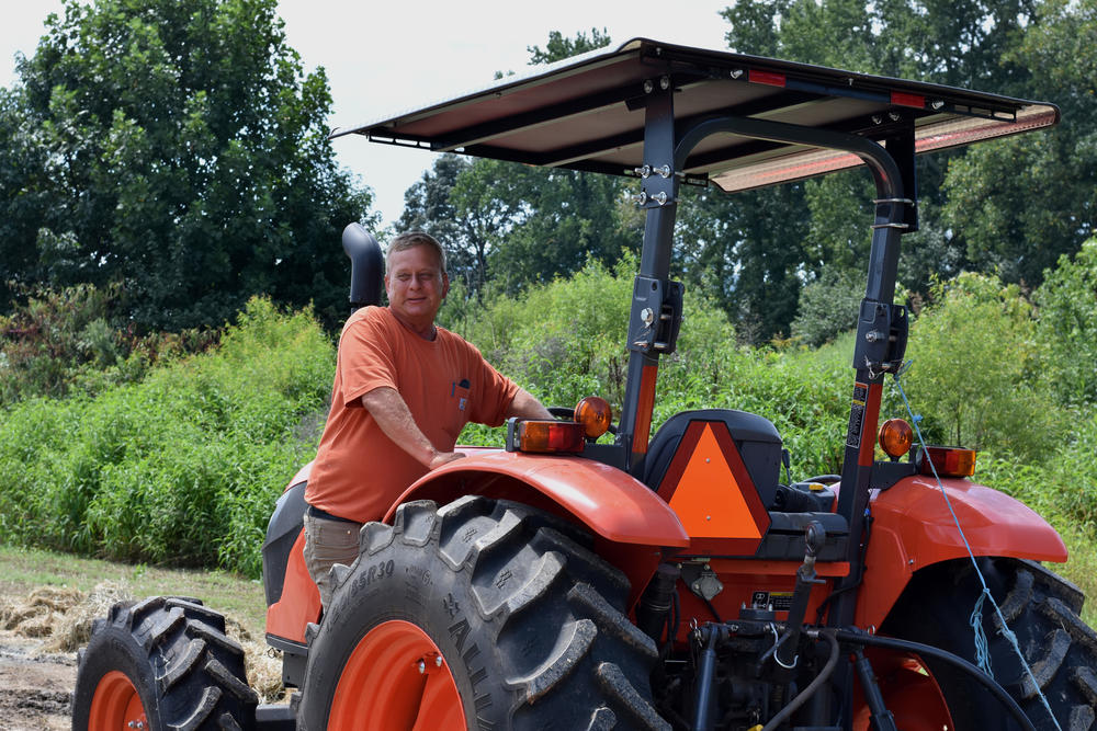 Paul Seabolt stands on a tractor at Seabolt Farms in Cleveland, Ga.