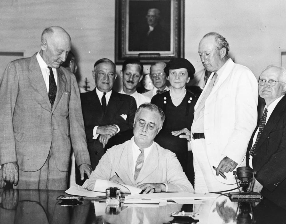 President Franklin D. Roosevelt signs the Social Security Act into law on August 14, 1935.