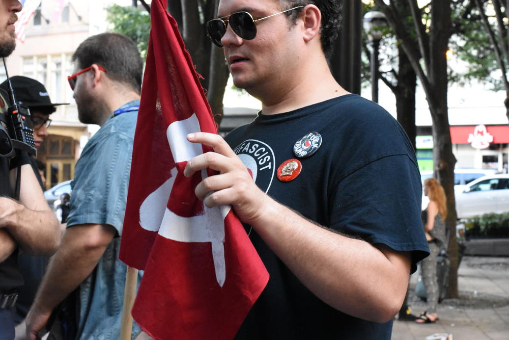Drew Smith, who self-identifies as a Communist, stands in Woodruff Park before an anti-white nationalist rally.