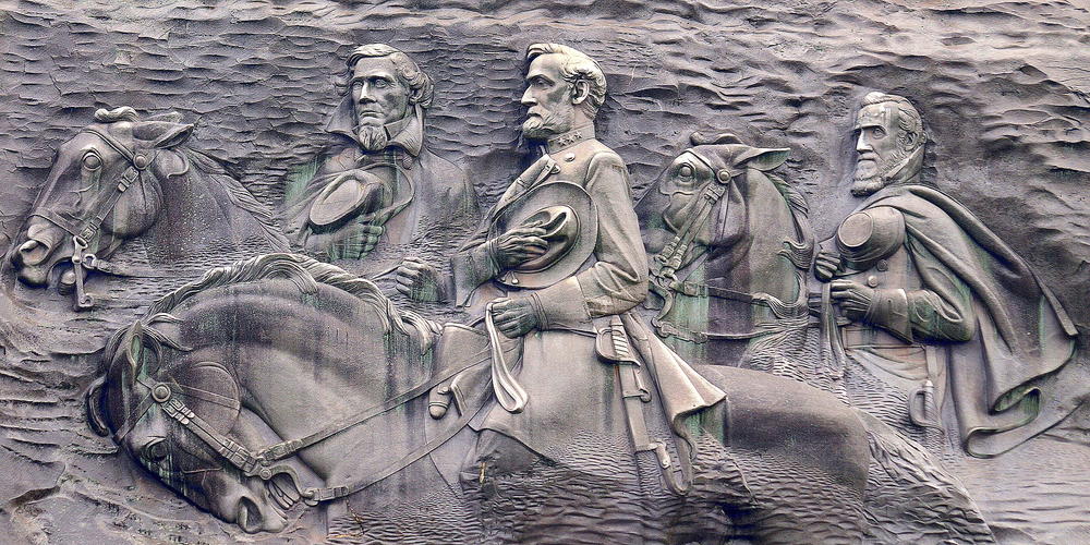 Carvings at Stone Mountain depicting three Confederate figures during the Civil War: Stonewall Jackson, Robert E. Lee, and Jefferson Davis.