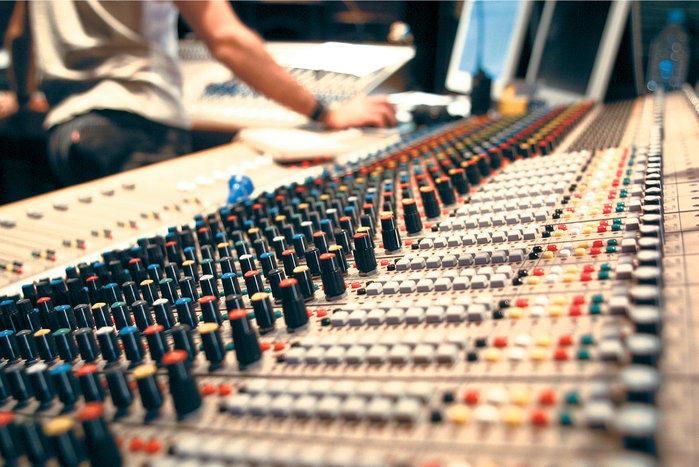 A mixing console inside a recording studio