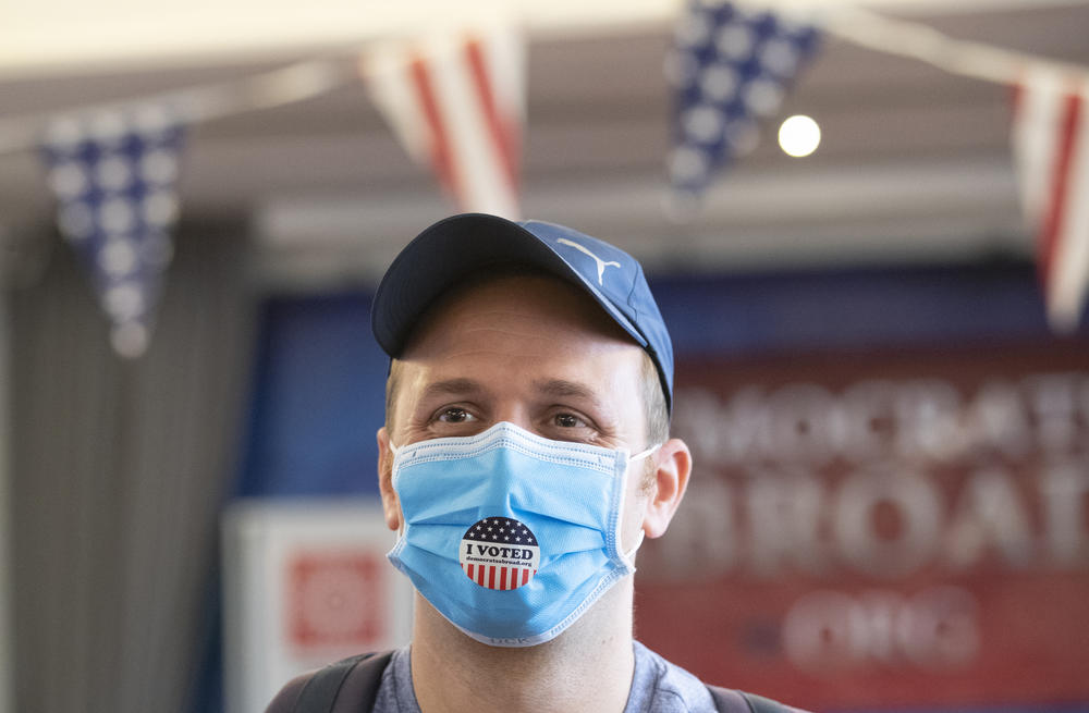 Elliott Zaagman from Michigan put wears his mask after casting vote on the Super Tuesday, for U.S. Democrats Abroad multi-location global primary at Foreign Correspondents' Club of Thailand, Tuesday, March 3, 2020.