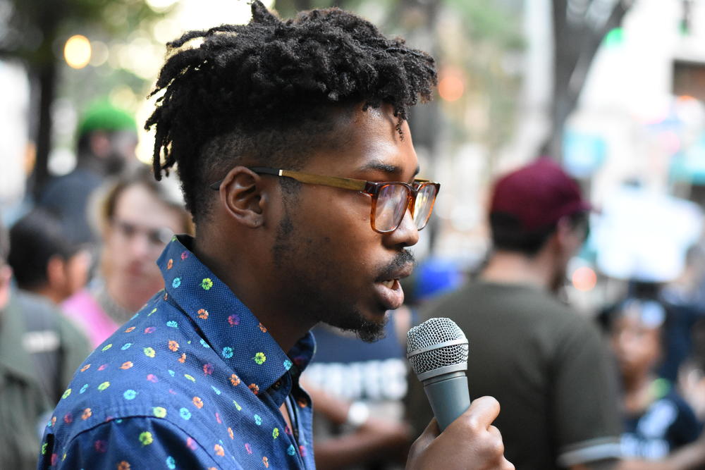 Brian Thompson speaks at an anti-white nationalist rally in Woodruff Park on Sunday, August 13.