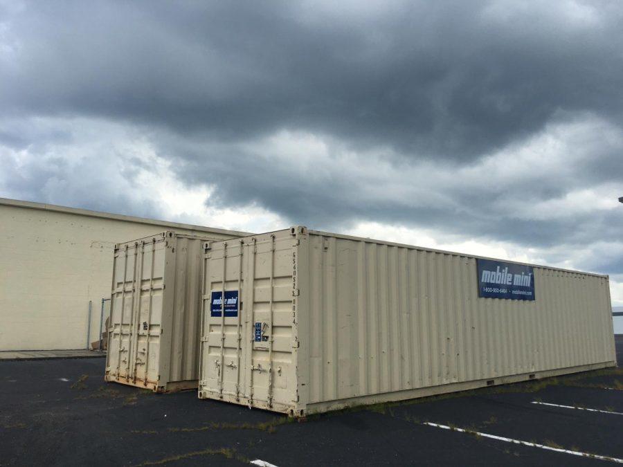Two rented shipping containers behind the Macon-Bibb County Board of Elections represent just one of the added expenses for the state's new voting machines.