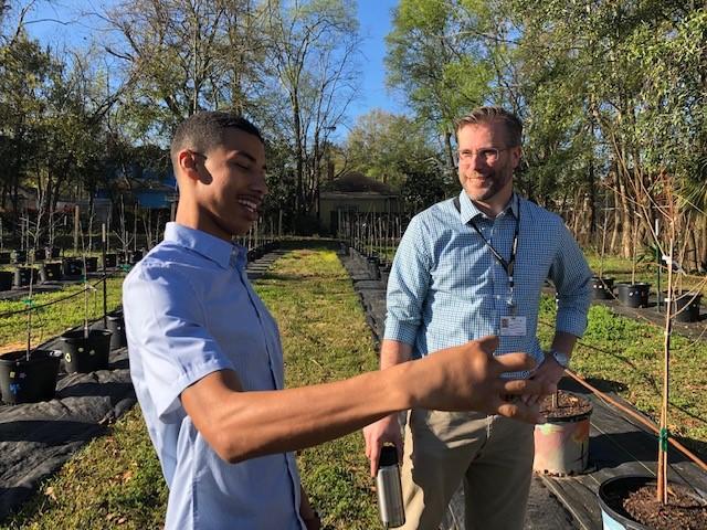 Apprentice arborist Robert Hartwell talking with sustainability director Nick Deffley