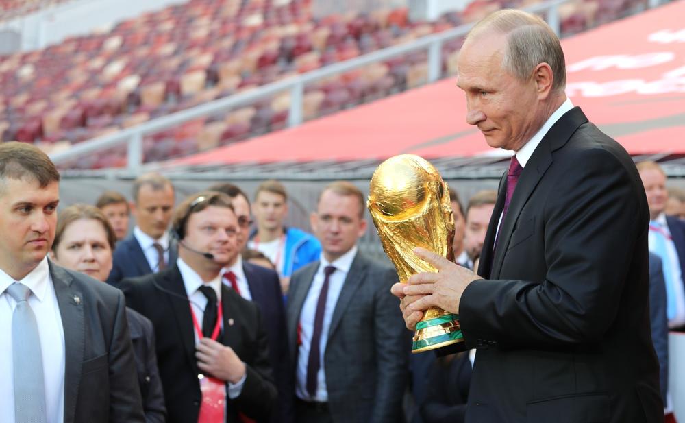 Russian president Vladimir Putin holding the FIFA World Cup Trophy at a pre-tournament ceremony in Moscow, September 2017
