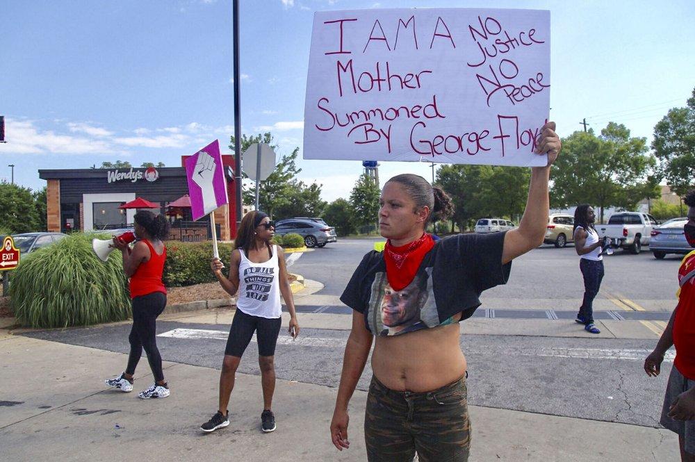 Protestors gather outside the Wendy's fast food restaurant in Atlanta on Saturday, June 13, 2020, where Rayshard Brooks, a 27-year-old black man, was shot and killed by Atlanta police Friday evening during a struggle in a drive-thru line. 