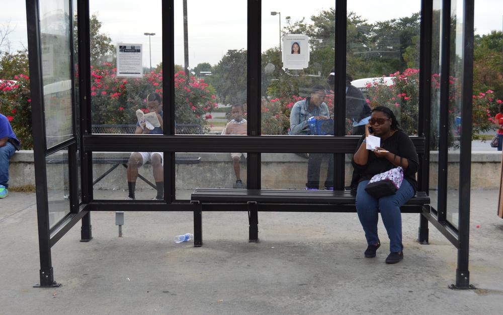 Yvette MacPherson and other commuters waiting for their Gwinnett County Transit (GCT) bus.