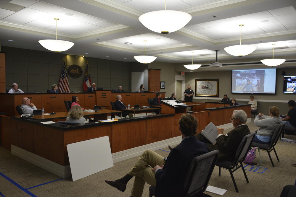 The Kennesaw City Council and Mayor Derek Easterling listen to public comments on a resolution to replace the Confederate flag from the historic downtown area. 