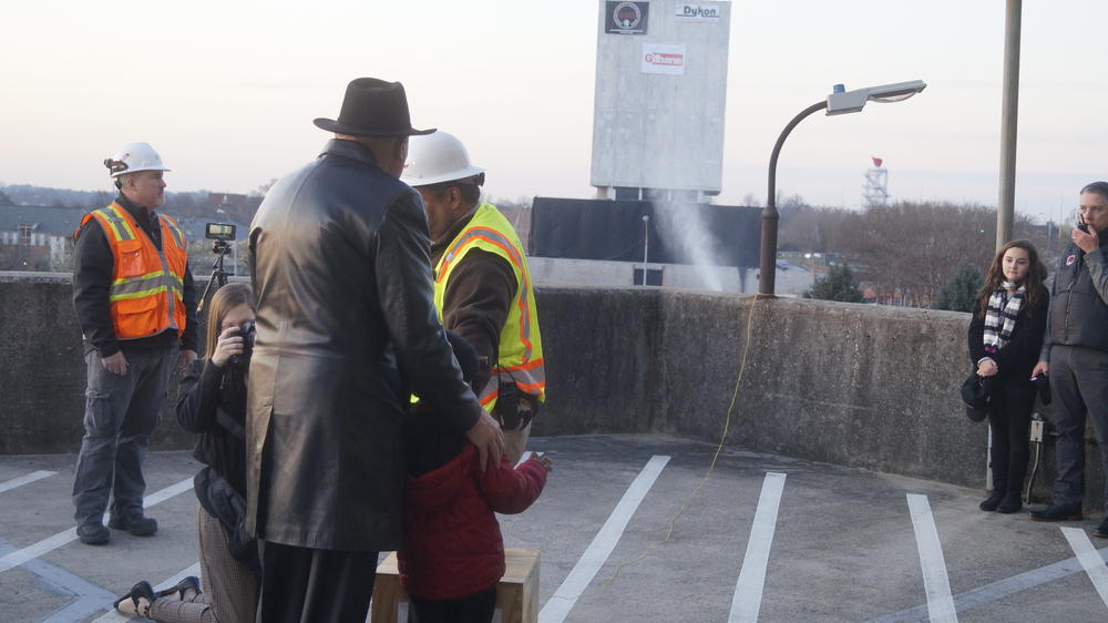 Governor Nathan Deal stands with 5-year-old Children's Healthcare of Atlanta patient Devin Simmons as they await the countdown to implosion of the Georgia Archives building
