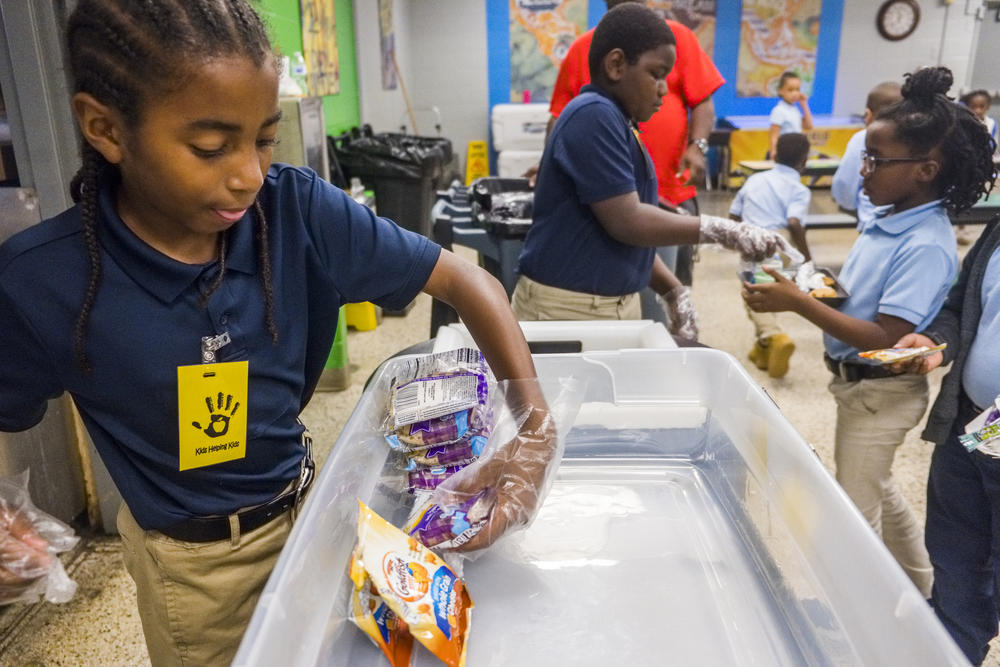 International Studies Elementary Charter students collect unopened food at lunch which will later be sent home with students to provide weekend meals. 