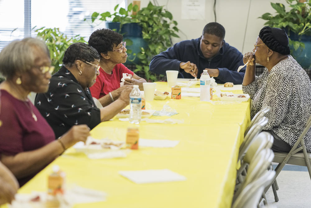 Betty Rouse, top left, and Ida McClinton talk while sharing lunch at the Twiggs County Senior Center in Jeffersonville. Studies show that eating together is better for seniors since they tend to eat more in each other's company.