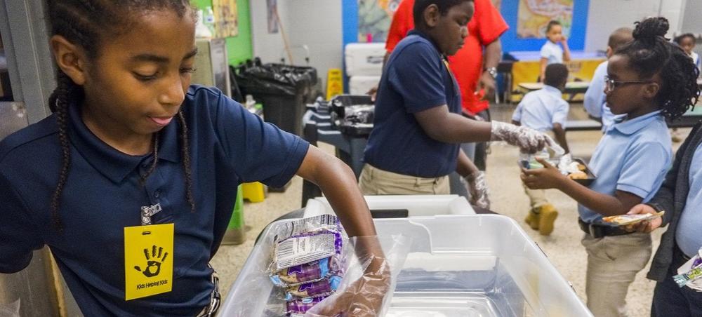 International Studies Elementary Charter students collect unopened food at lunch which will later be sent home with students to provide weekend meals.