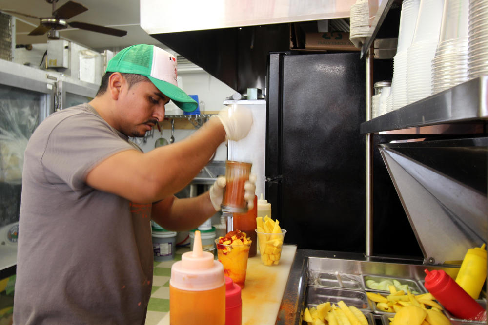 Adrian Saucedo-Luviano prepares a fruit smoothie for a customer at La Calentana, the bakery and takeout restaurant he owns and operates in Tifton. He is awaiting his date in immigration court after being arrested in Houston County.