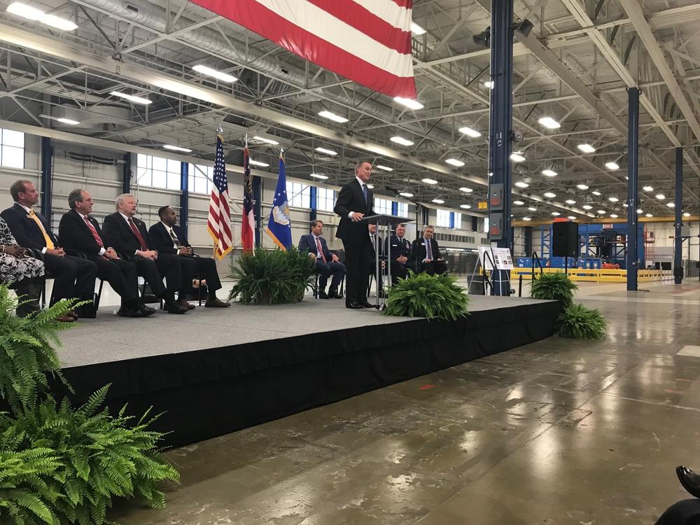 Senator David Perdue speaks to crowd at the former Boeing plant in Macon while Governor Brian Kemp and others look on