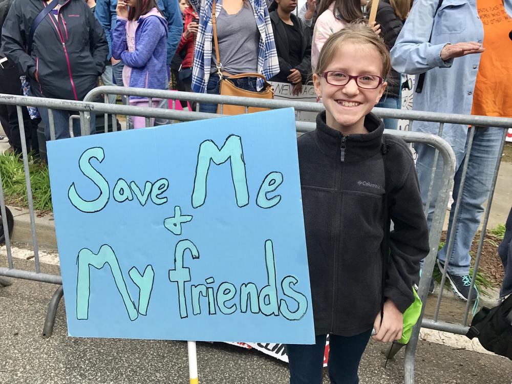 11-year-old Anneleise Dunn proudly holds the sign she carried at the March For Our Lives Rally on Saturday, March 24, 2018, in Atlanta.