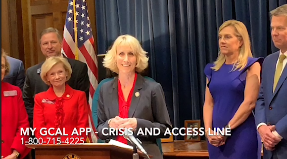 Judy Fitzgerald speaks Thursday, Feb. 14, during Gov. Brian Kemp's press conference about the Georgia Crisis and Access Line app.