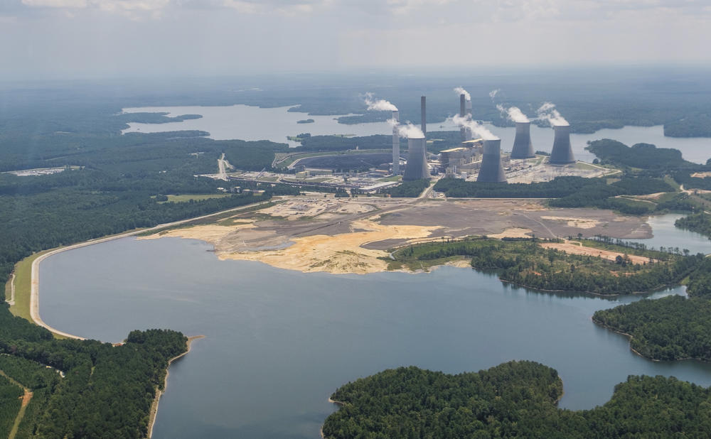 Georgia Power's Plant Scherer with the coal ash pond, foreground, where residuals from burning coal at the plant are stored. The pond goes to depths of 80 feet in some places and comes into contact with groundwater. 