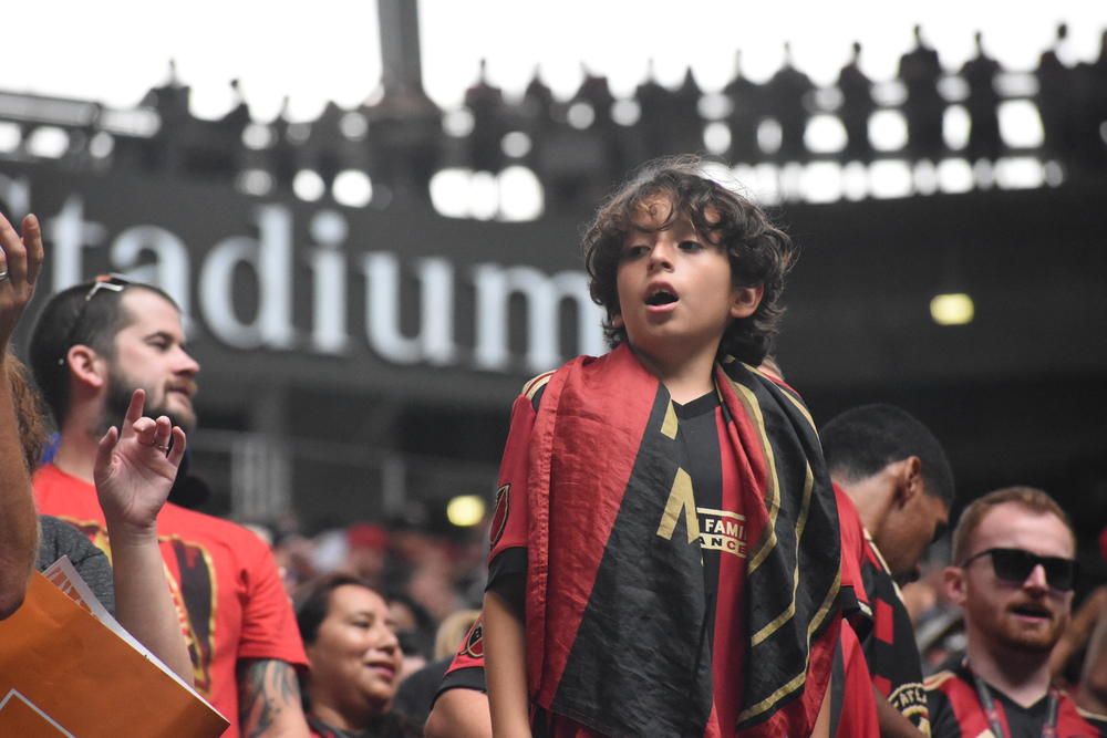 A young ATL United fan takes in the action at Mercedes Benz Stadium.