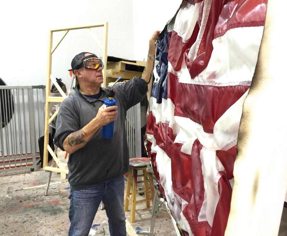 In his art, Bernie Taupin features American flags that may be crumpled up or even burned. This, he says, comes from a place of patriotism, and families of fallen servicemen have even given Taupin their flags to incorporate into his art.