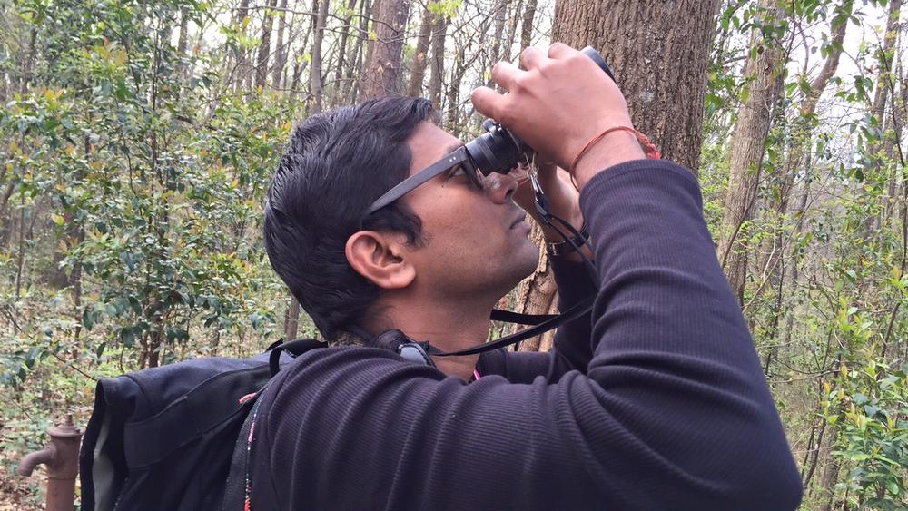 Vinod Babu helps  lead a bird watch near the Fernbank Museum in Atlanta on March 19, 2016.