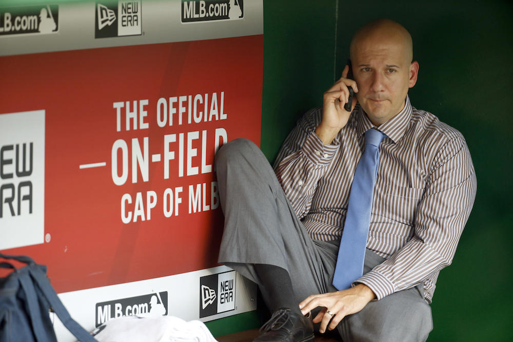 John Coppolella talks on the phone in the dugout during batting practice before a baseball game against the Washington Nationals at Nationals Park, Friday, Sept. 4, 2015, in Washington.