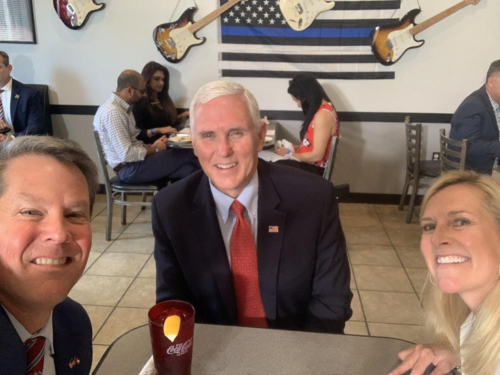 Vice President Mike Pence eats lunch with Georgia Gov. Brian Kemp and his wife Marty Kemp at the Star Cafe, Friday, May 22, 2020, in Atlanta. 