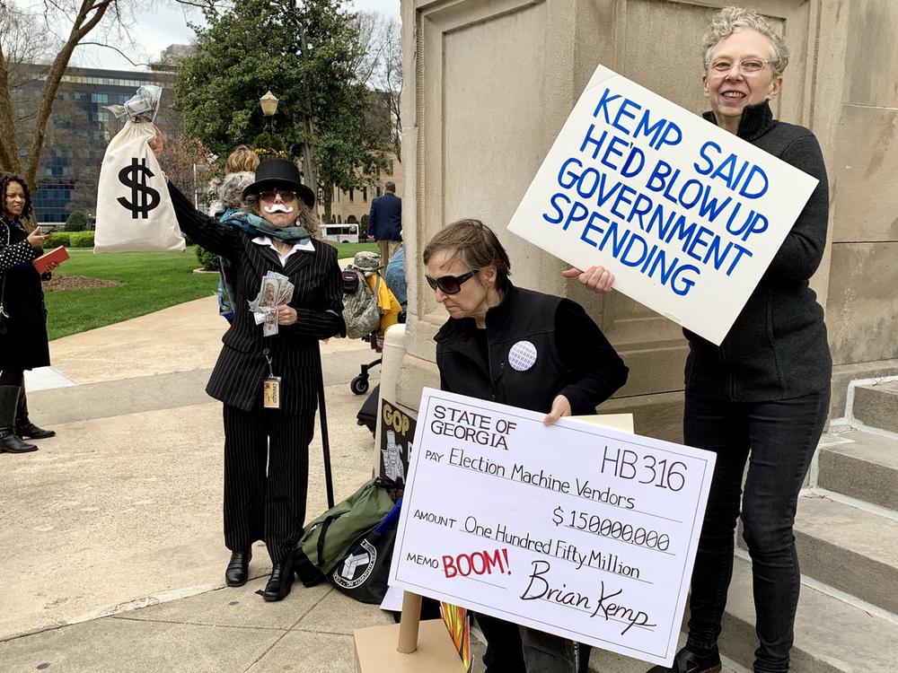 A group of protestors opposing a law overhauling the states voting system demostrate on the steps of the Georgia State Capitol. 