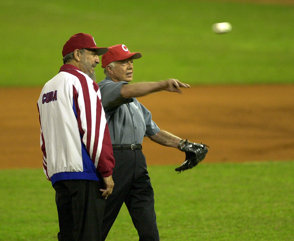 FILE - In this May 14, 2002 file photo, former U.S. President Jimmy Carter, right, accompanied by Cuban leader Fidel Castro, warms up before throwing the first pitch in an all-star baseball game at the Latin American Stadium in Havana, Cuba. Castro has died at age 90. President Raul Castro said on state television that his older brother died late Friday, Nov. 25, 2016.