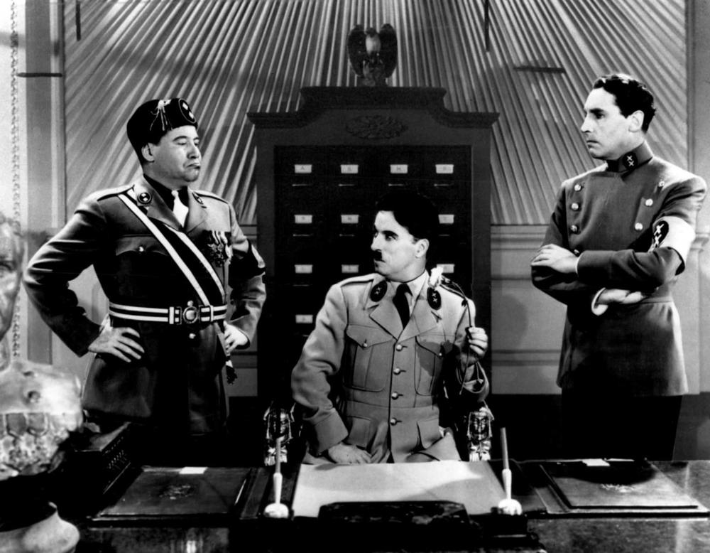 Actor Charlie Chaplin is seen in the film "The Great Dictator," as Adenoidal Hynkel, center, and Jackie Oakie as Napaloni, left, and Henry Daniell as Garbitsch, 1940. 