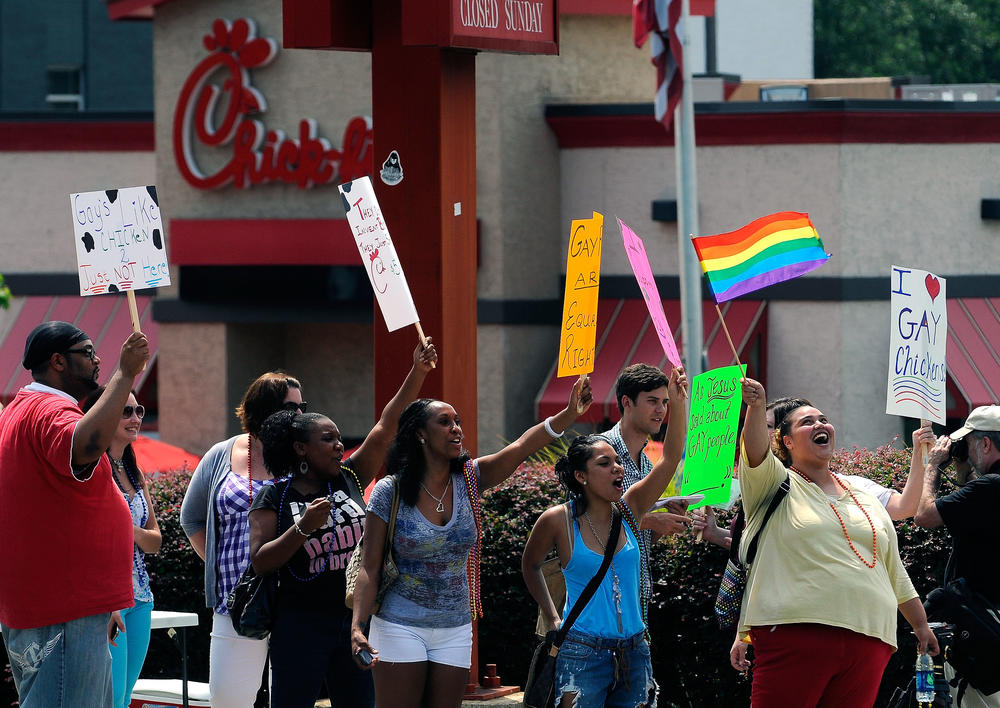 Gay rights groups and others protest and hold a "kiss-in" outside the Decatur, Ga., Chick-fil-A restaurant Friday, Aug. 3, 2012 as a public response to a company official who was quoted as supporting the traditional family unit. 