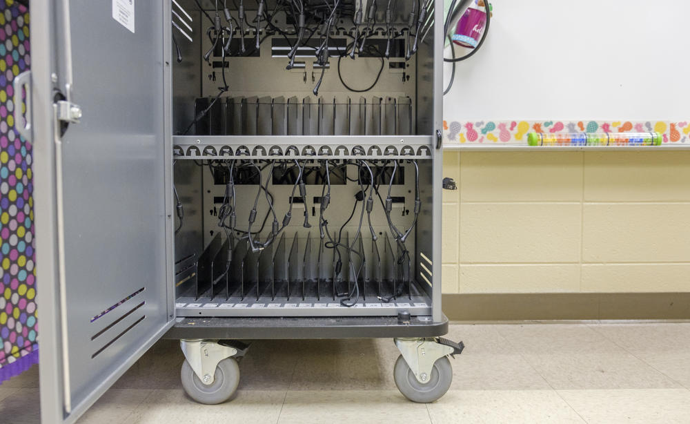 The empty cart of Chromebooks sits in Hutchins' room.