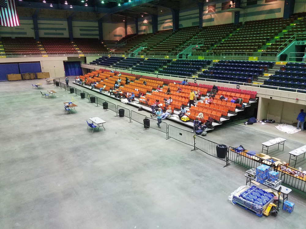 People sleep in the bleachers at the Savannah Civic Center during Hurricane Dorian.