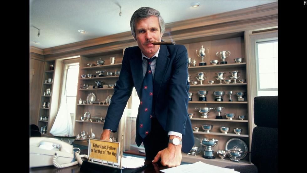 Ted Turner, stands behind his desk at CNN. 