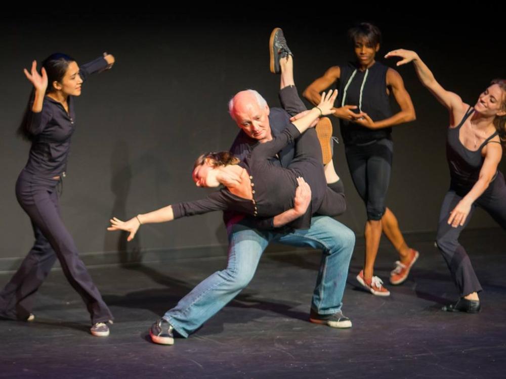 Colin Mochrie performs with dancers at Dad's Garage.