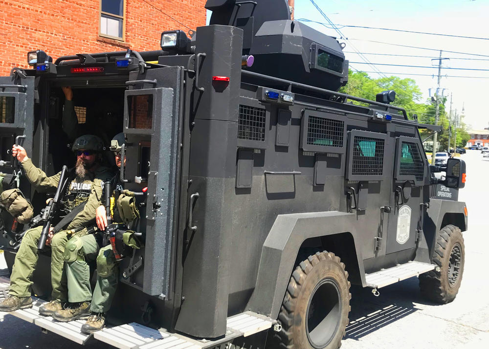 An armored convoy rolls down one of Newnan's closed streets on April 21, 2018. 