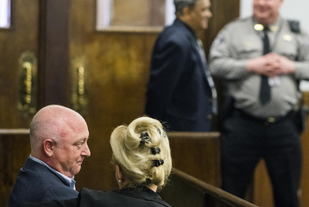 Steve Firestone, left, owner of Crystal Lake Holdings LLC, waits for the start of his hearing in Bibb County Municipal Court Friday. Firestone's attorneys convinced the court to bind Firestone's case over to state court.