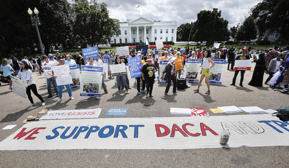 In this Sunday, Sept. 3, 2017 photo, supporters of Deferred Action for Childhood Arrivals program (DACA), demonstrate on Pennsylvania Avenue in front of the White House in Washington. 