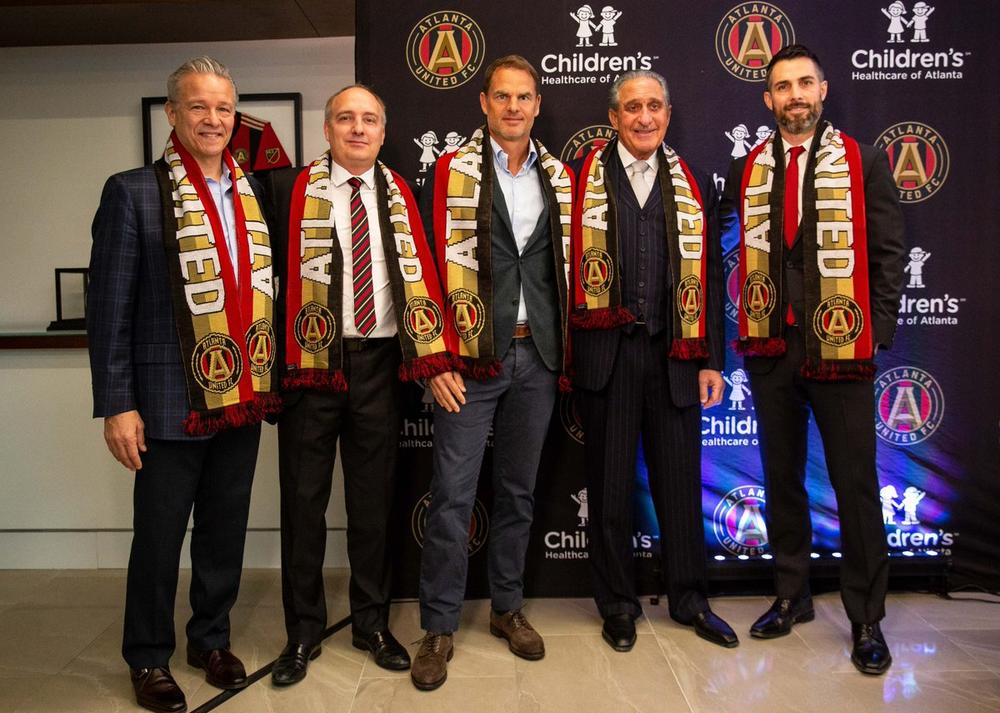 de Boer (center) met team owner's Arthur Blank (second from right) at a press conference Monday.. 