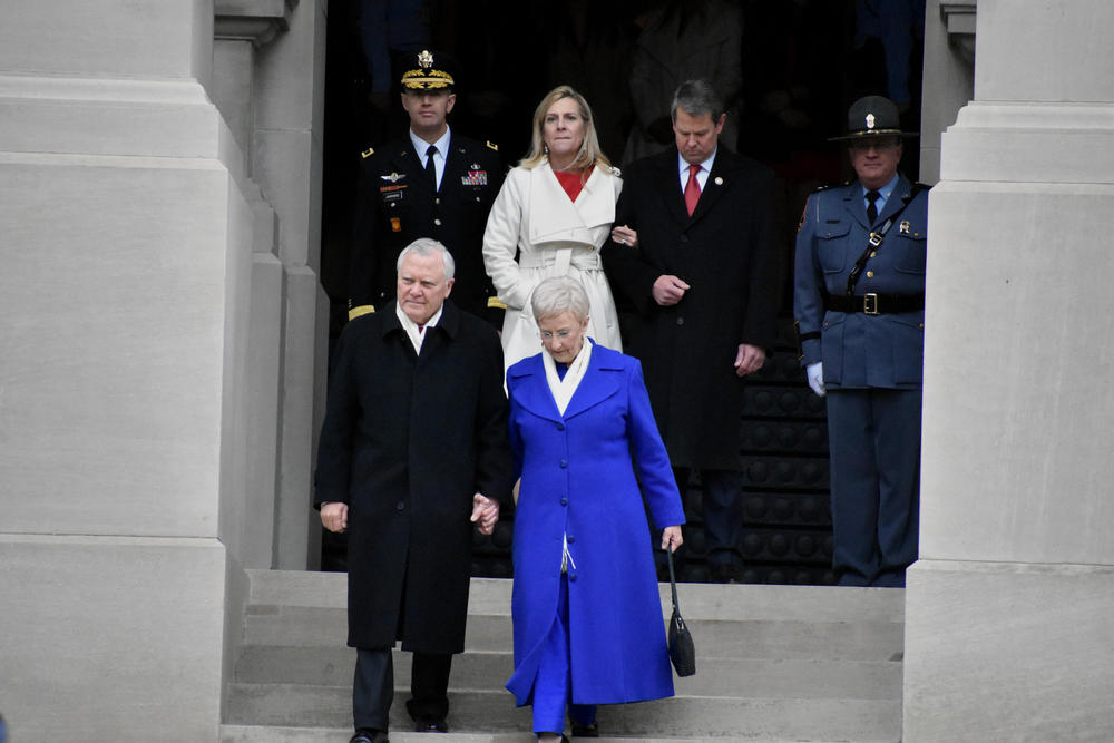 Outgoing Governor Nathan Deal and his wife Sandra leave the State Capitol one final time as new Governor Brian Kemp and his wife Marty look on.