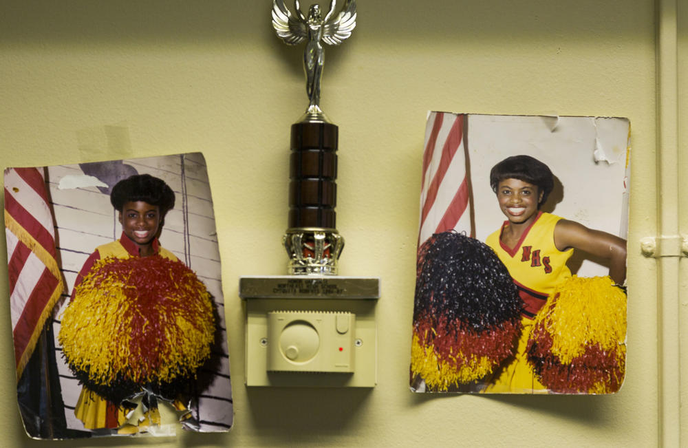 Chiquita Dinkins keeps two photos of herself as Northeast High's head cheerleader on the wall behind her classroom desk. 