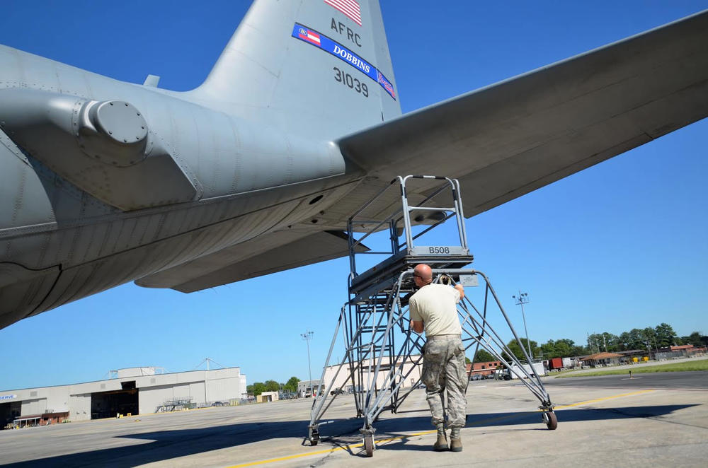 Staff Sgt. John McDermott, 94th Maintenance Squadron avionics instruments and flight control, moves a ladder used to reach C-130 engines at Dobbins Air Reserve Base in this photo from September 2016. The base is hosting those quarantined with coronavirus.