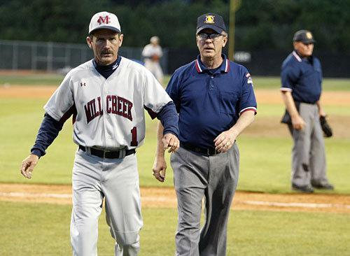 Mill Creek Head Baseball Coach Doug Jones advises players duringa game.