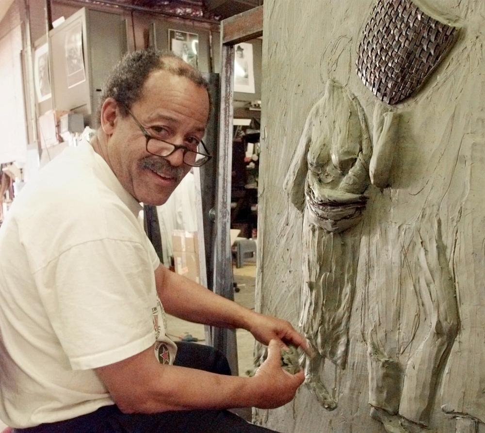 Sculptor Ed Dwight works on the third panel of a twelve panel piece in his studio in Denver, Colo., on Aug. 5, 1999.