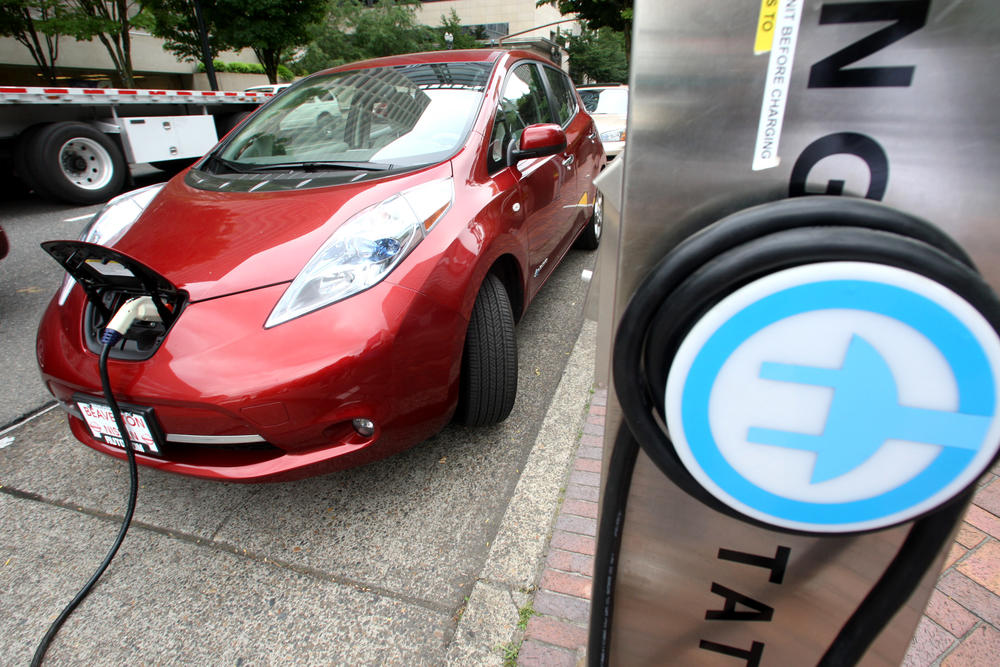 A Nissan Leaf charges at an electric vehicle charging station in Portland, Oregon.