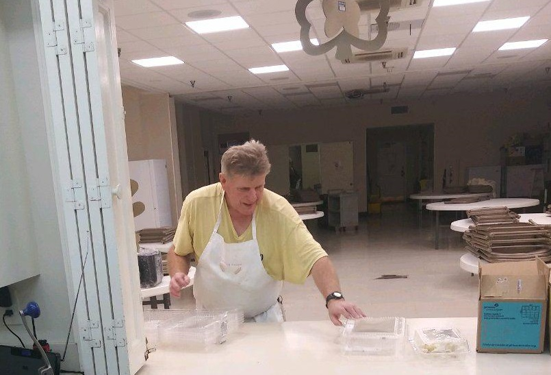 Emmaus House Clinic Supervisor Wayne Harden packages meals in to-go containers. The soup kitchen is serving meals to-go instead of in their dining hall to help stop the spread of coronavirus.