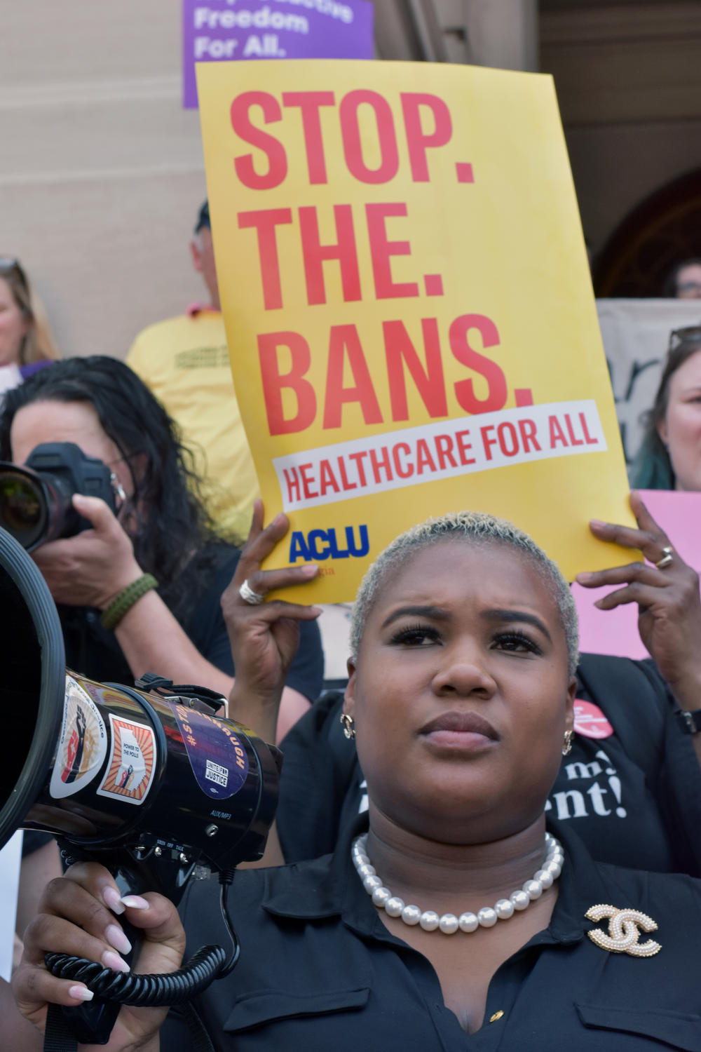 State Rep. Erica Thomas (D-Austell) holds a megaphone at a rally against abortion bans at the state capitol building.