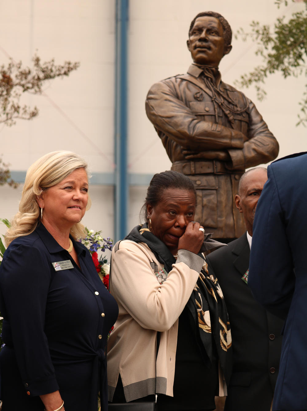 Harriet Bullard-White wipes away tears as the statue of Eugene Bullard is unveiled at Robins Air Force base. 